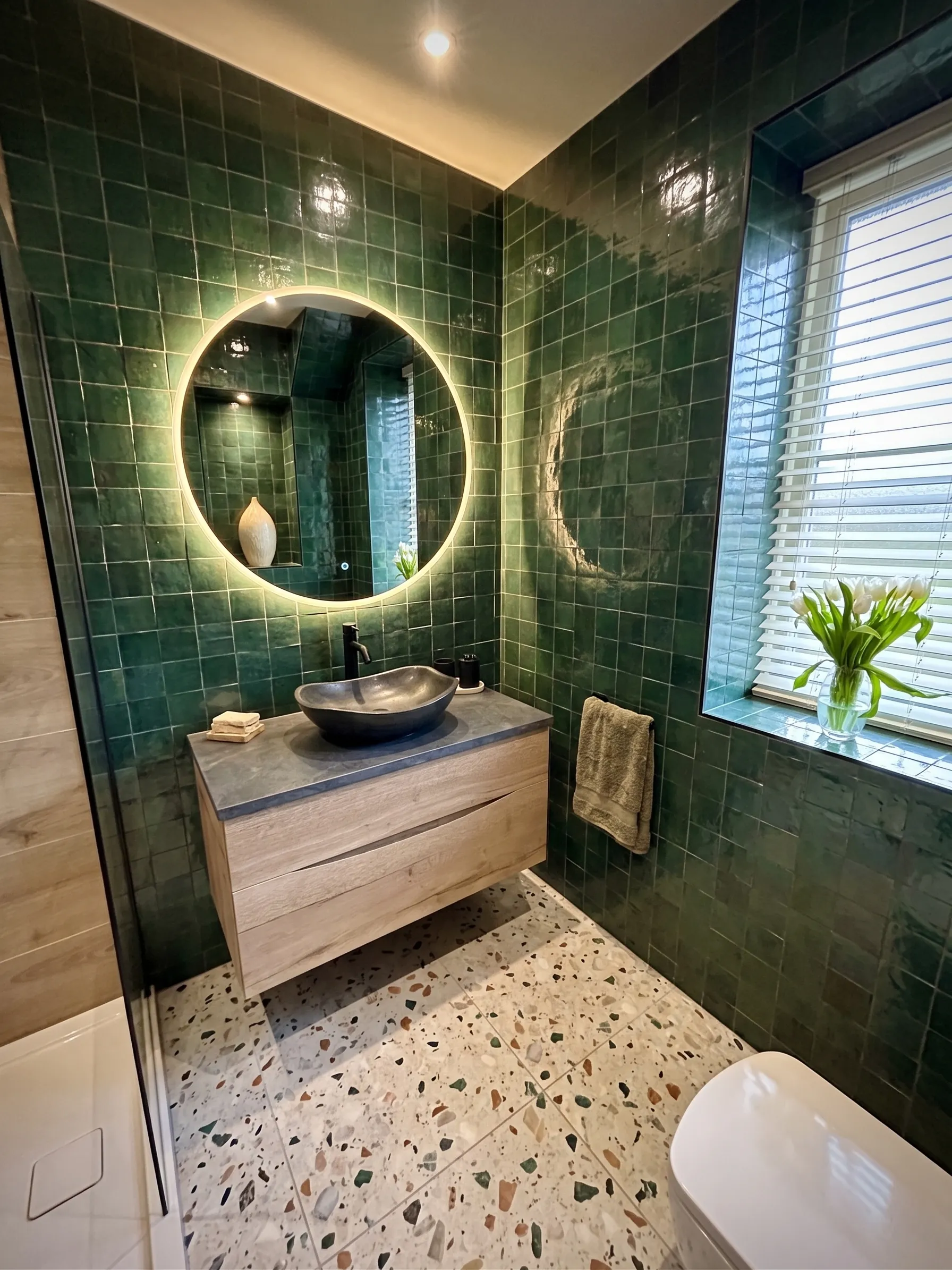 A clean bathroom with a spotless sink, toilet and bath.